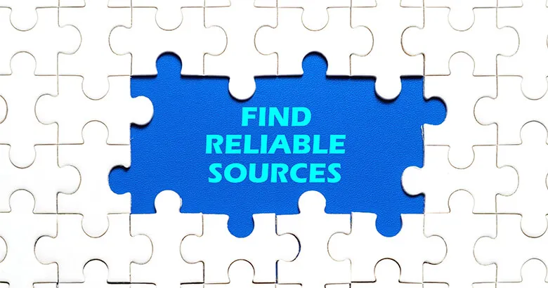White jigsaw puzzle pieces around a blue center containing the words find reliable sources