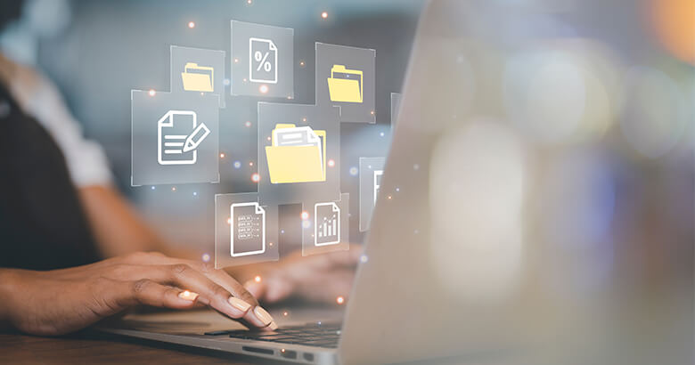 Female hands typing in laptop and transparent images of files and folders blended in